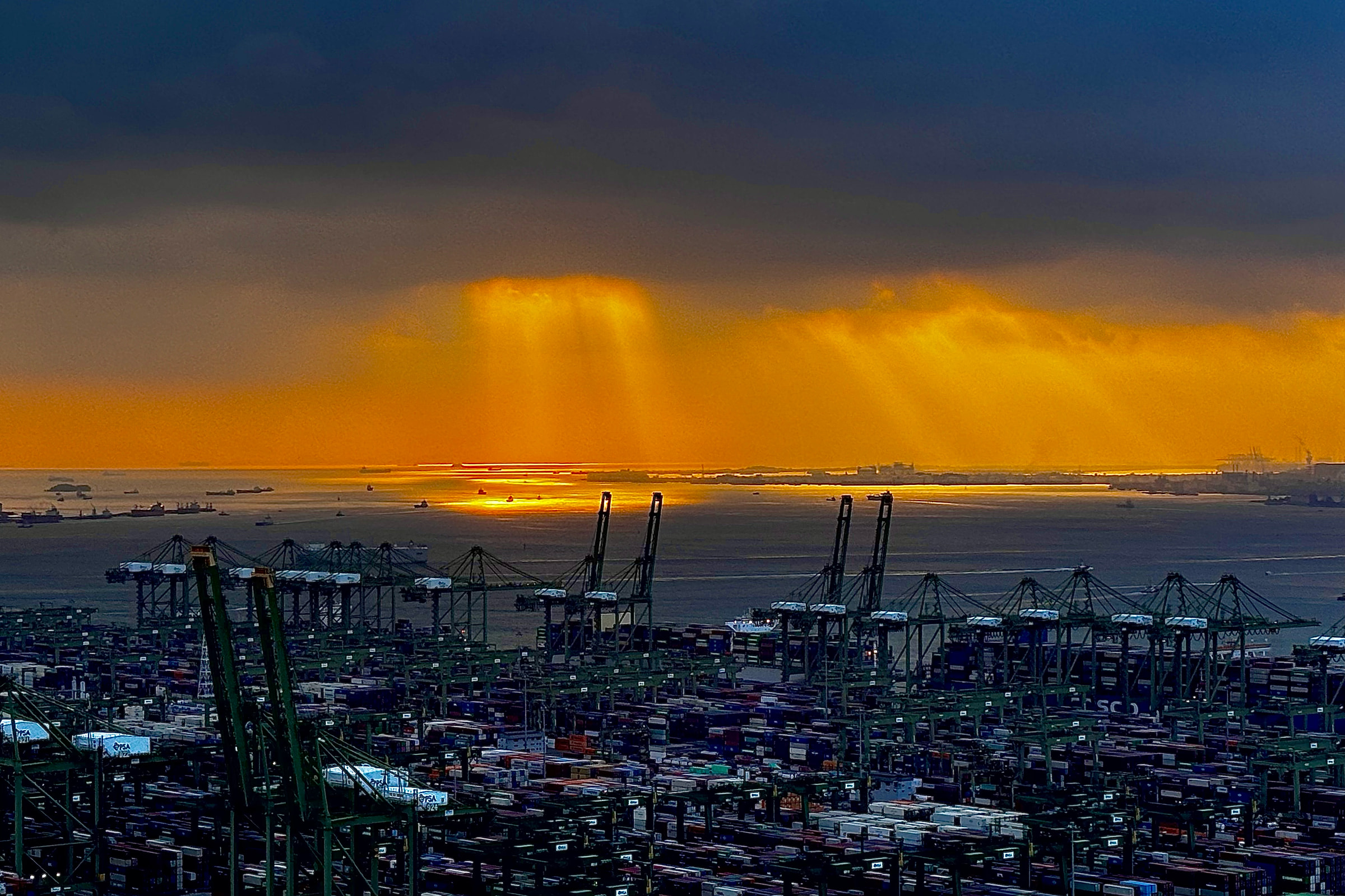 Container ship under way at sunset