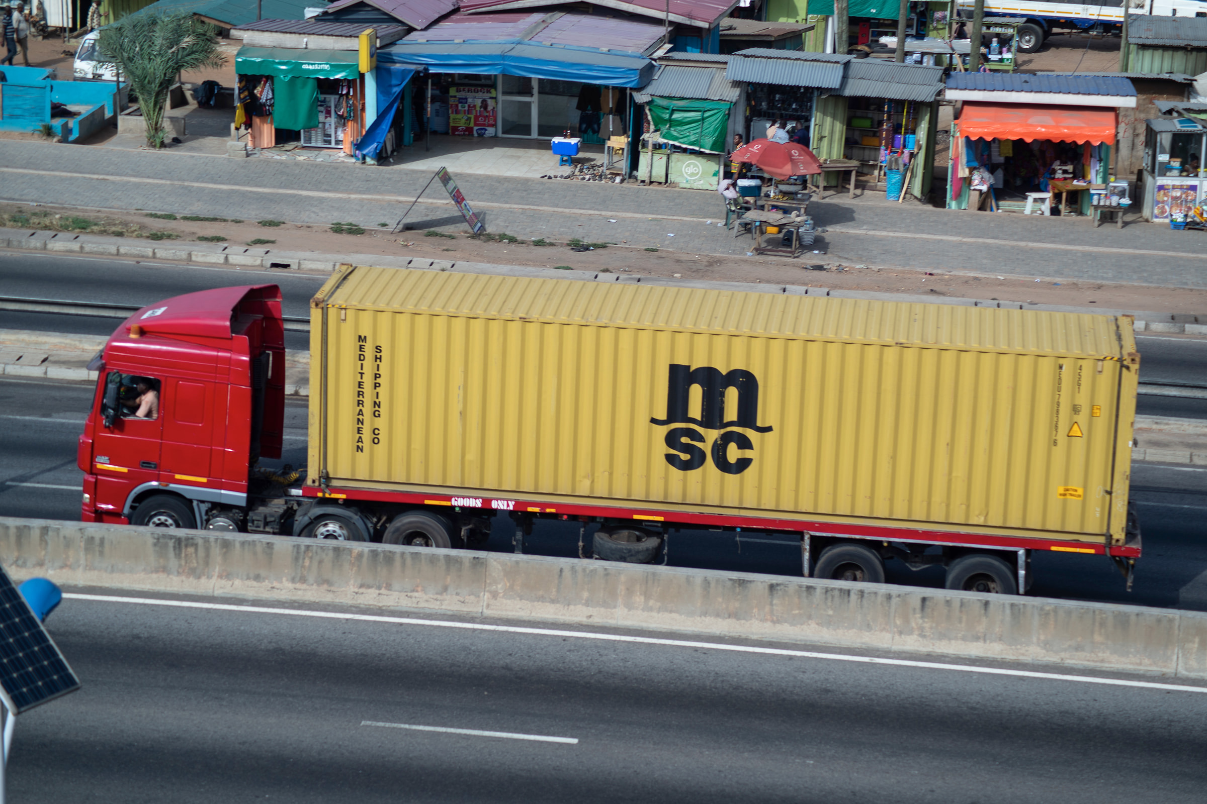 Haulage trucks moving containers inland